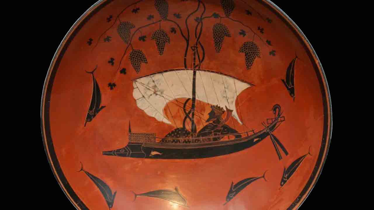 Interior of a black-figure kylix depicting Dionysus on a ship festooned with grapevines sailing among jumping dolphins